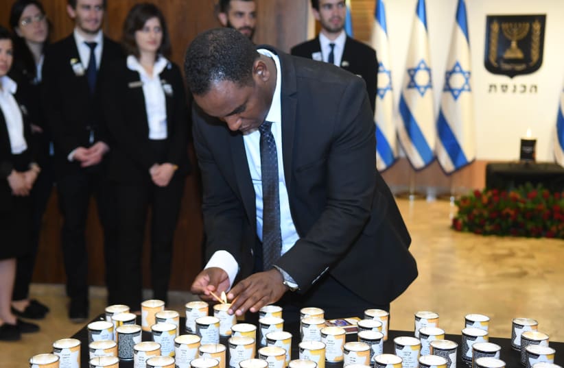 Freshman Knesset member Gadi Yevarkan lights a candle in memory of the victims of the Holocaust at the Knesset's annual “Every Person Has a Name” ceremony, May 2 2019. (photo credit: KNESSET SPOKESMAN'S OFFICE)