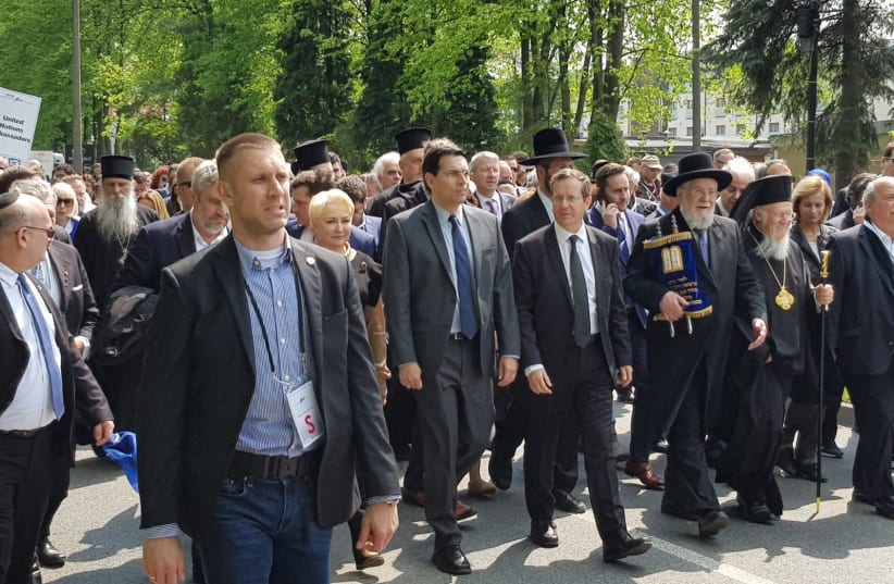 Israeli Ambassador to the UN Danny Dannon alongside Chairman of the Jewish Agency for Israel Isaac Herzog walk alongside one another during the March of the Living, 2019. (photo credit: EYTAN HALON)