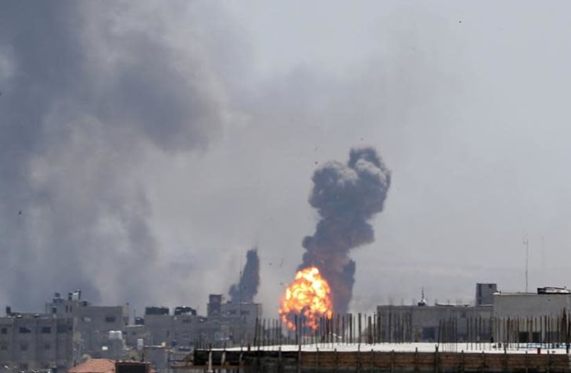 A ball of fire is seen during Israeli air strikes in Gaza May 4, 2019 (photo credit: REUTERS/MOHAMMED SALEM)