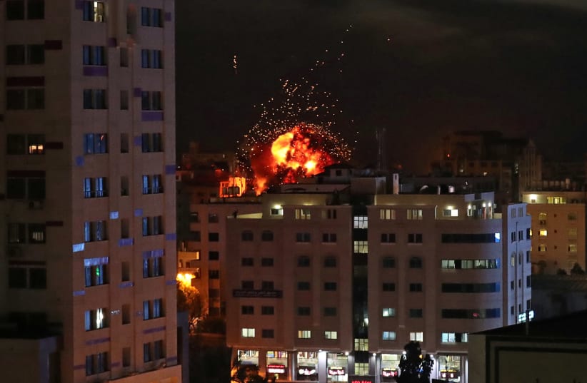 A ball of fire is seen during an Israeli air strike in Gaza City May 4, 2019. (photo credit: SUHAIB SALEM / REUTERS)