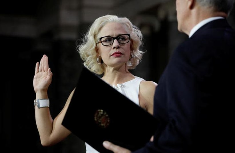 Sen. Kyrsten Sinema (D-AZ) participates in a mock swearing in with U.S. Vice President Mike Pence during the opening day of the 116th Congress on Capitol Hill in Washington (photo credit: REUTERS/AARON P. BERNSTEIN)