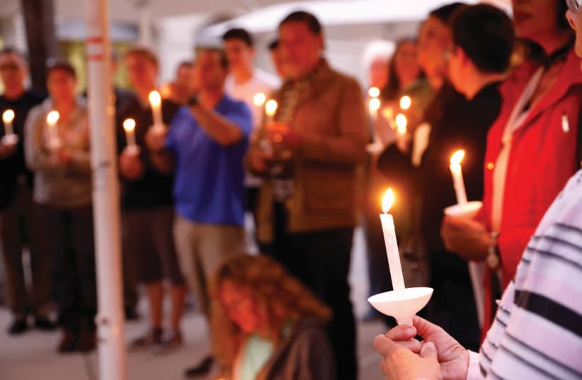 A CANDLELIGHT VIGIL is held at Rancho Bernardo Community Presbyterian Church for victims of the attack at the Chabad synagogue in Poway, California, April 27, 2019 (photo credit: JOHN GASTALDO/REUTERS)