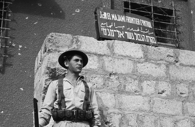 An IDF soldier stands guard outside the kibbutz Gesher police station during the War of independence.  (photo credit: GPO)