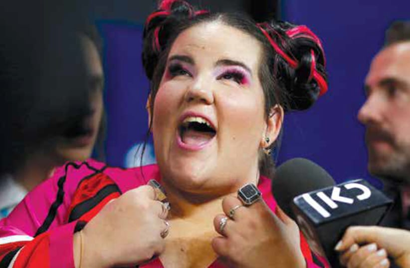 Israel’s Netta reacts after winning the Grand Final of Eurovision Song Contest 2018 at the Altice Arena hall in Lisbon, Portugal, last May. (photo credit: PEDRO NUNES/REUTERS)