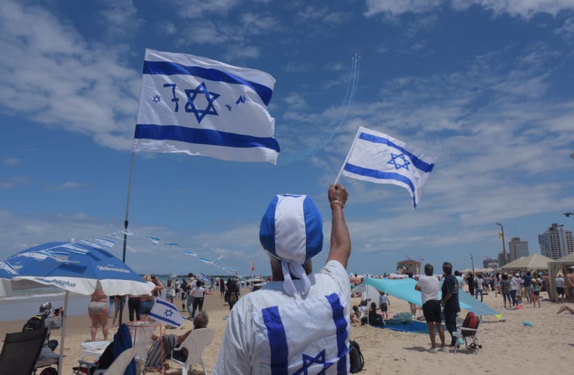 Israelis celebrate Independence Day on the beach, 2019. (photo credit: AVSHALOM SASSONI)