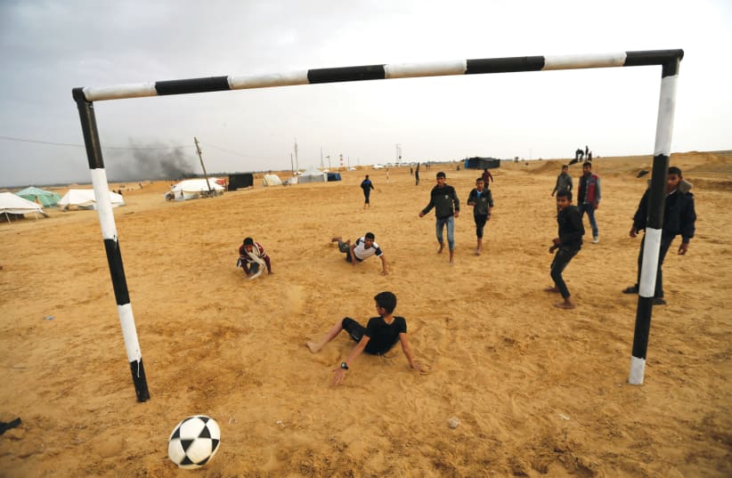 PALESTINIANS PLAY soccer at a tent city in the southern Gaza Strip last year.  (photo credit: IBRAHEEM ABU MUSTAFA/REUTERS)