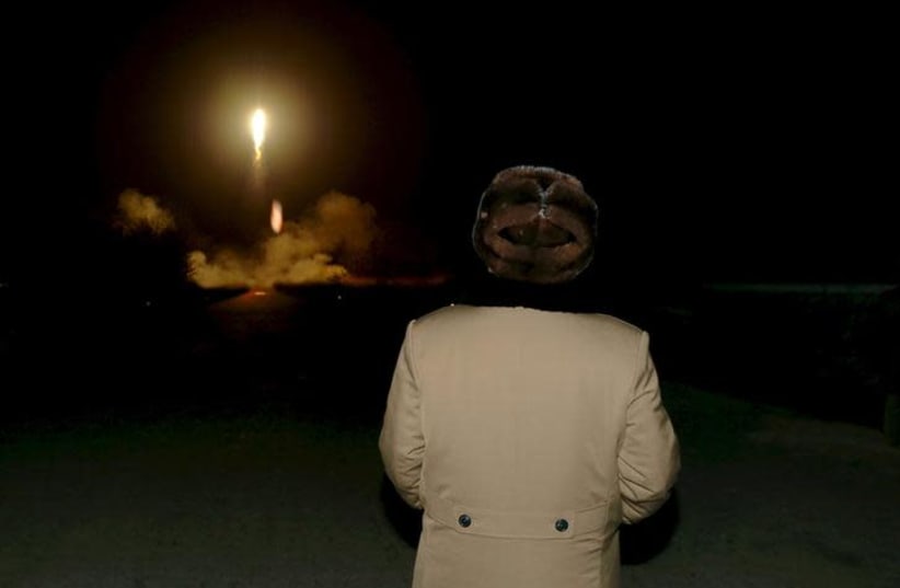 North Korean leader Kim Jong Un watches the ballistic rocket launch drill of the Strategic Force of the Korean People's Army (KPA) at an unknown location (photo credit: REUTERS)