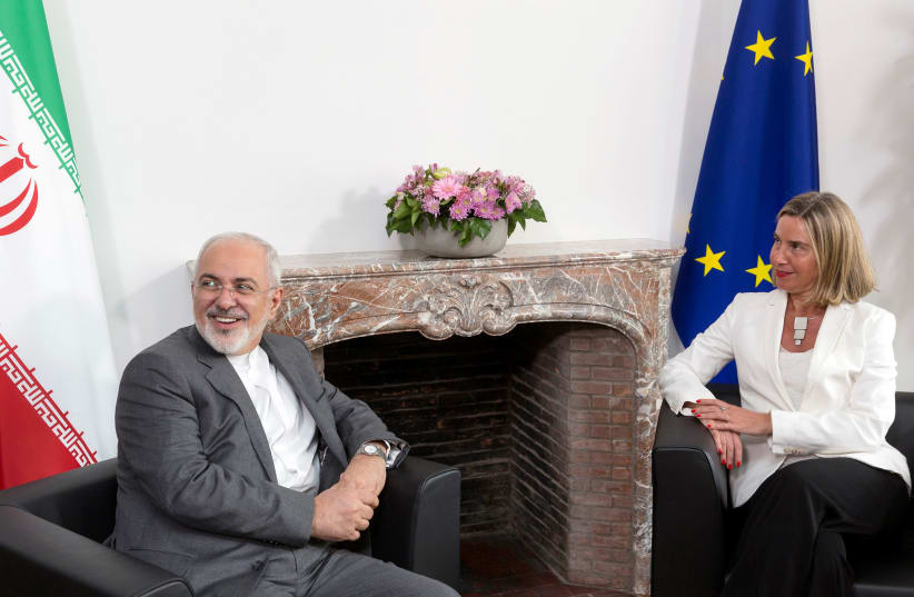 Iran's Foreign Minister Mohammad Javad Zarif attends a meeting with European Union foreign policy chief Federica Mogherini at the EU Council in Brussels, Belgium, May 15, 2018 (photo credit: THIERRY MONASSE/POOL VIA REUTERS)