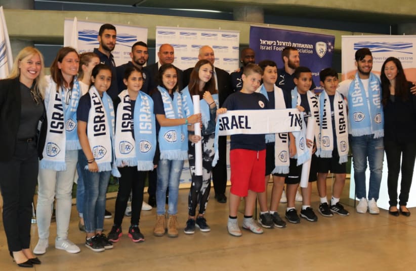 Israeli soccer players join school children from Jaffa at the Peres Center for Peace and Innovation (photo credit: Courtesy)