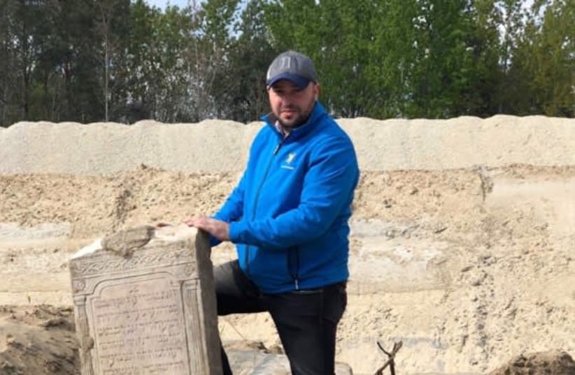 rom the Depths founder, Jonny Daniels, poses with some of the Jewish tombstones recovered in Gora Kalwaria in Poland (photo credit: FROM THE DEPTHS)