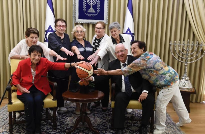 President Reuven Rivlin and the women who played on the Israeli 1950 basketball team    (photo credit: Mark Neiman/GPO)