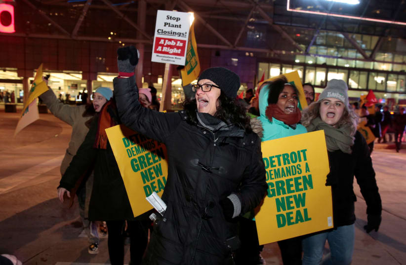 Democratic Congresswoman Rashida Tlaib joins female activists during a rally to protest General Motors in Detroit, Michigan (photo credit: REBECCA COOK / REUTERS)