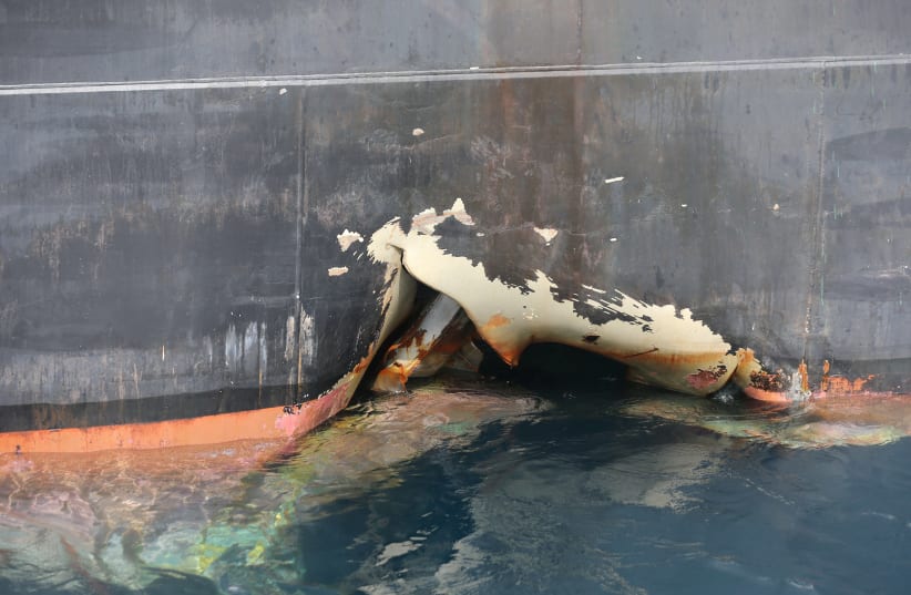 A damaged ANDREA VICTORY ship is seen off the Port of Fujairah, United Arab Emirates, May 13, 2019.  (photo credit: SATISH KUMAR/REUTERS)