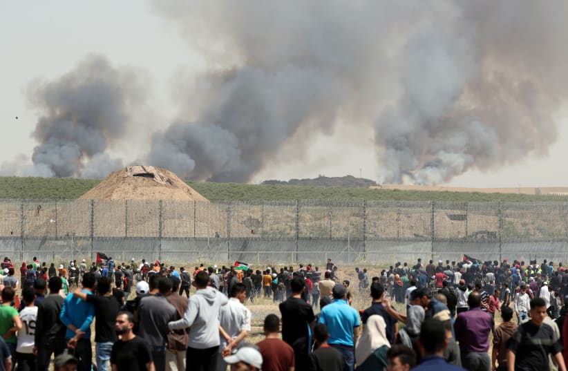 Fires near the Gaza border seen in background of Nakba Day protests 2019 (photo credit: REUTERS/MOHAMMED SALEM)