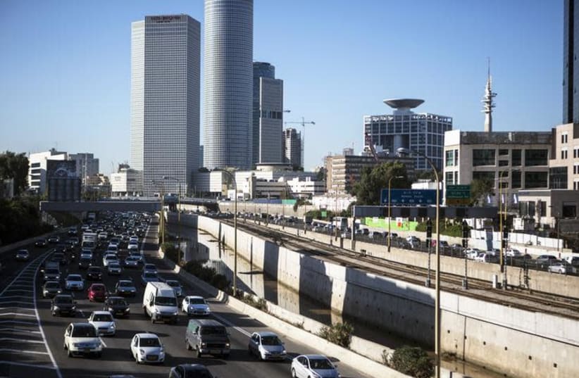 Vehicles drive on a highway in the central Israeli city of Tel Aviv (photo credit: NIR ELIAS / REUTERS)