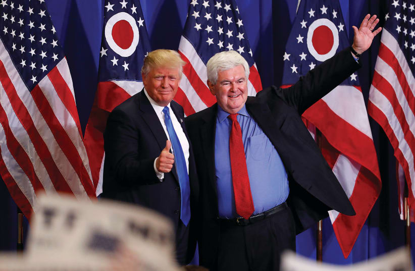FORMER US SPEAKER of the House Newt Gingrich greets then-US Republican presidential candidate Donald Trump at a rally in Cincinnati, Ohio, in 2016. (Aaron P. Bernstein/Reuters) (photo credit: YONATAN SINDEL/FLASH 90)