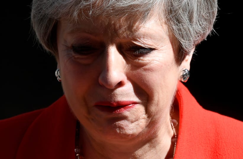 British Prime Minister Theresa May tears up as she delivers a statement announcing her resignation in London  (photo credit: TOBY MELVILLE/REUTERS)
