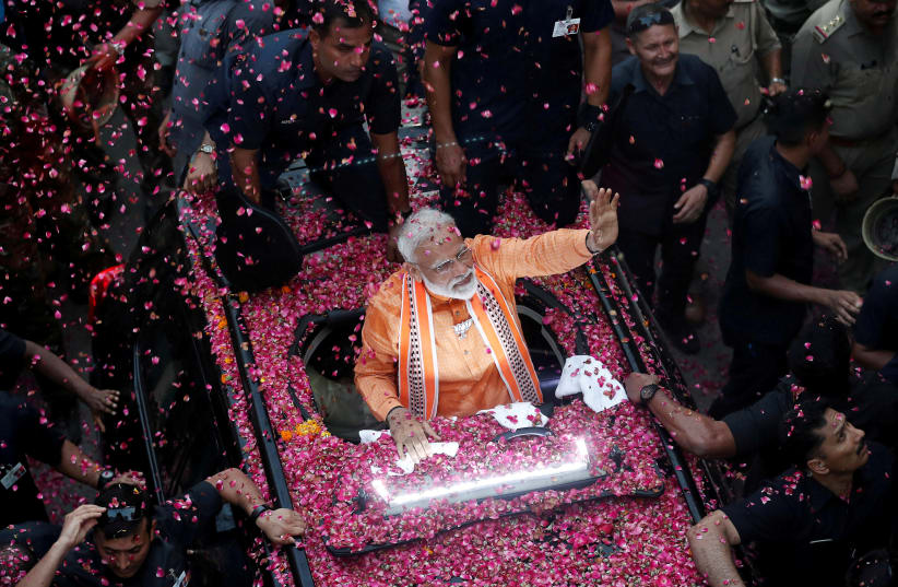  India's Prime Minister Narendra Modi waves towards his supporters during a roadshow in Varanasi, India (photo credit: ADNAN ABIDI/ REUTERS)