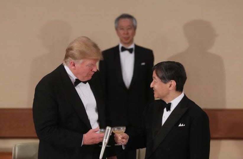 U.S. President Donald Trump toasts with Japan's Emperor Naruhito (photo credit: REUTERS/JONATHAN ERNST)