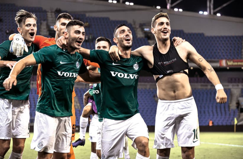 MACCABI HAIFA players celebrate after the team's 2-1 victory over Maccabi Netanya on Saturday, a result that enabled the Greens to secure a Europa League berth in the final match of the Israel Premier League season (photo credit: ARIEL SHALOM)