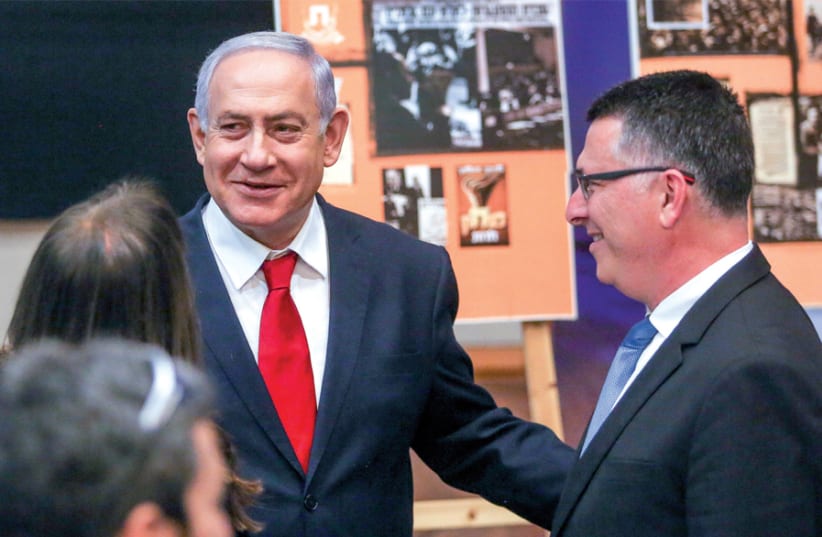 Prime Minister Benjamin Netanyahu chats with Likud MK Gideon Sa’ar, who has voiced opposition to the immunity bill that would grant the prime minister and members of Knesset political immunity from criminal proceedings (photo credit: MARC ISRAEL SELLEM)