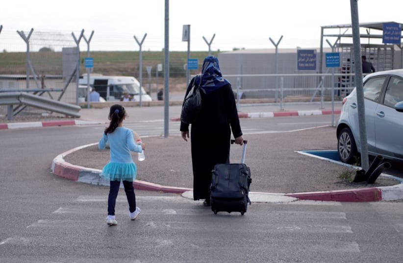 A Palestinian woman and her daughter enter Israel from Gaza (photo credit: GISHA)