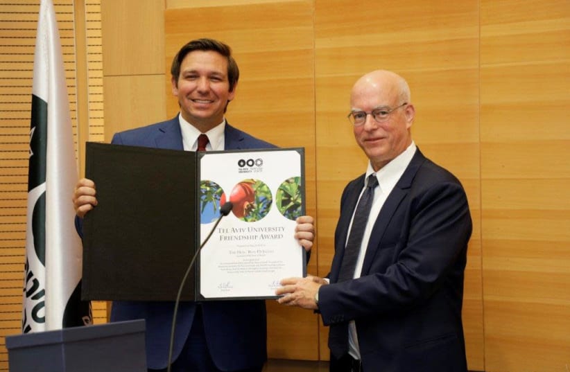 Governor Ron DeSantis (left) receives an award from Tel-Aviv University President Prof.Ariel Porat (photo credit: YEHONATAN ZUR DUVDEVANI)