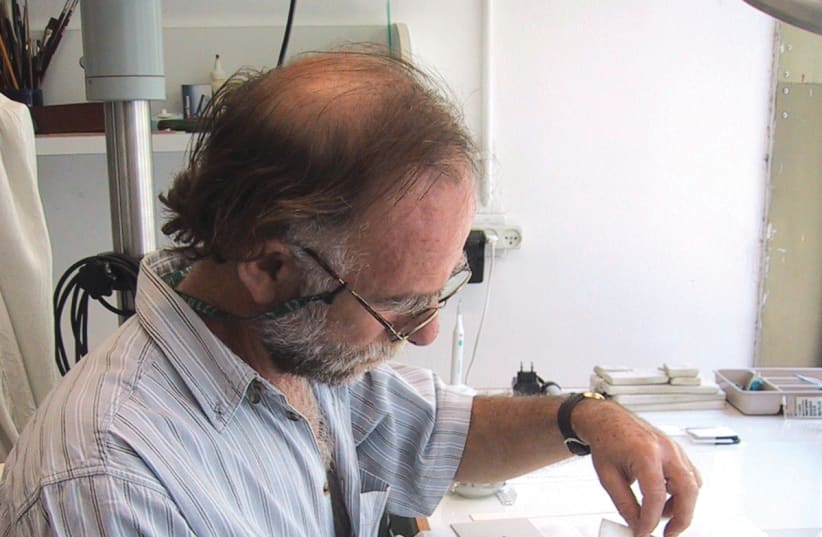 Michael Maggen separating the pages in the Israel Museum laboratory (photo credit: ISRAEL MUSEUM)