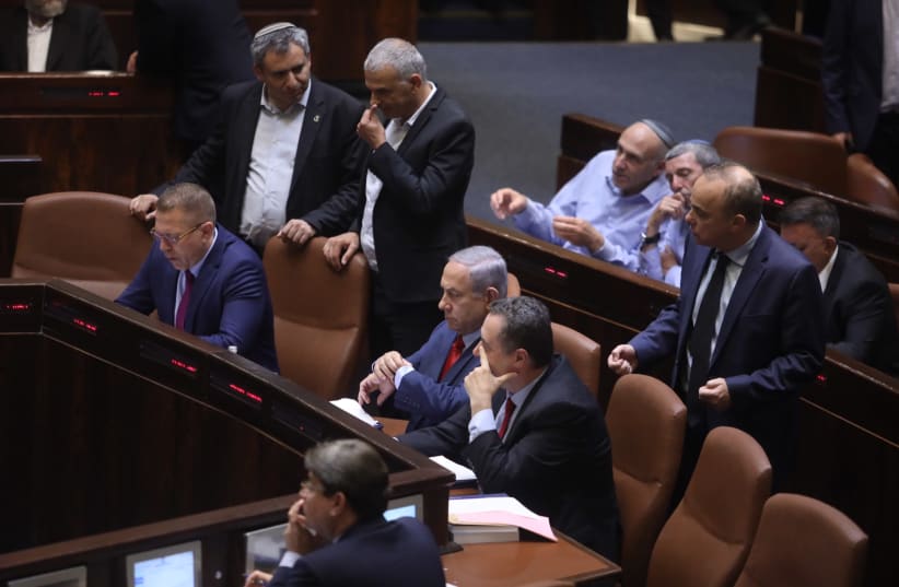 Prime Minister Benjamin Netanyahu sitting in the Knesset before the vote on Knesset dispersal. (photo credit: MARC ISRAEL SELLEM)