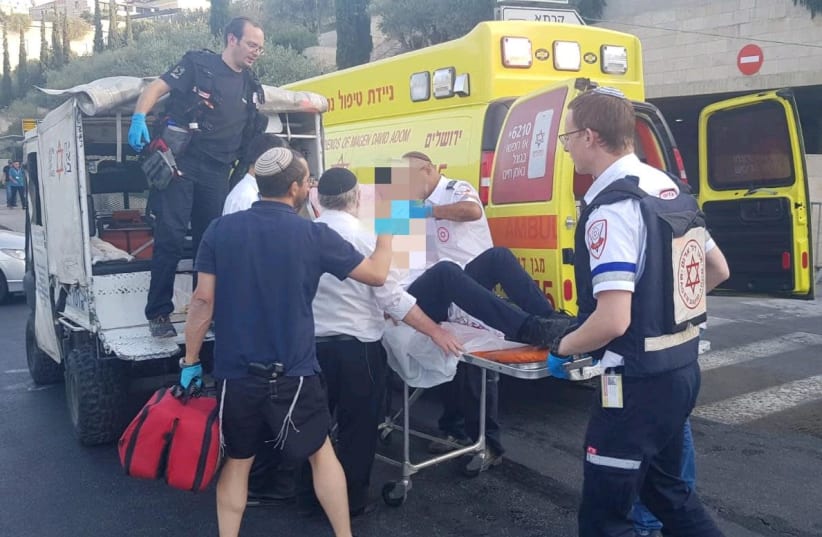 MDA paramedics evacuate a wounded man after he was stabbed in the Old City. (photo credit: MDA)