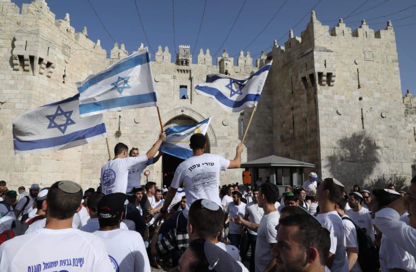 Israeli youth celebrate 'March of Flags' on Jerusalem Day, near the Damascus Gate, June 2, 2019  (photo credit: MARC ISRAEL SELLEM/THE JERUSALEM POST)