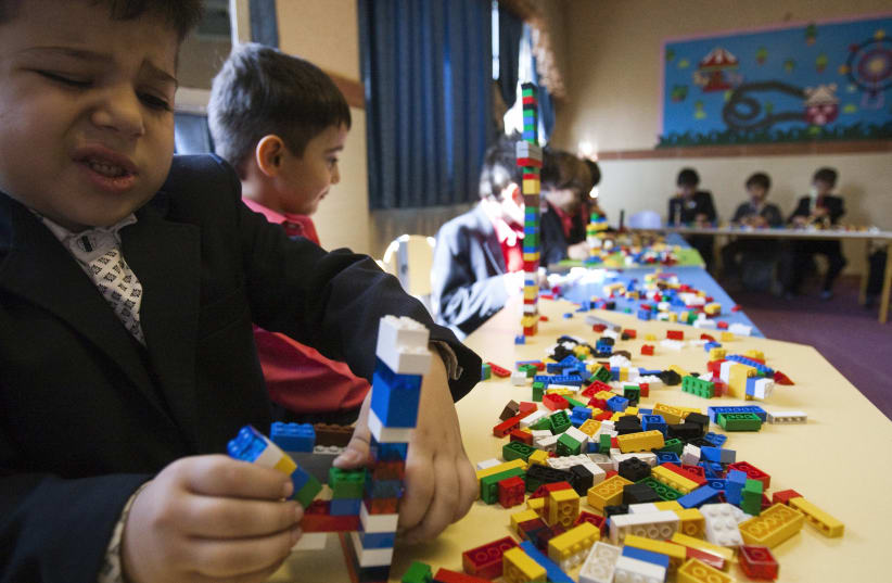 Students play with Lego bricks in the Pishtaz School in Tehran October 2011 (photo credit: REUTERS/RAHEB HOMAVANDI)