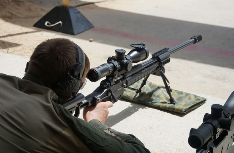 A marksman aims a Russian-made ORSIS sniper rifle at the ISDEF demonstration on June 3, 2019 (photo credit: SETH J. FRANTZMAN)