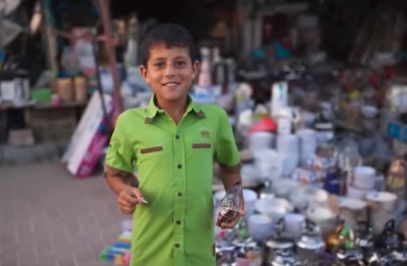 A Bedouin-Israeli boy holds home-made crafts for sale at the Desert Magic festival in the Negev city of Rahat from a promotional video for the event (photo credit: screenshot)