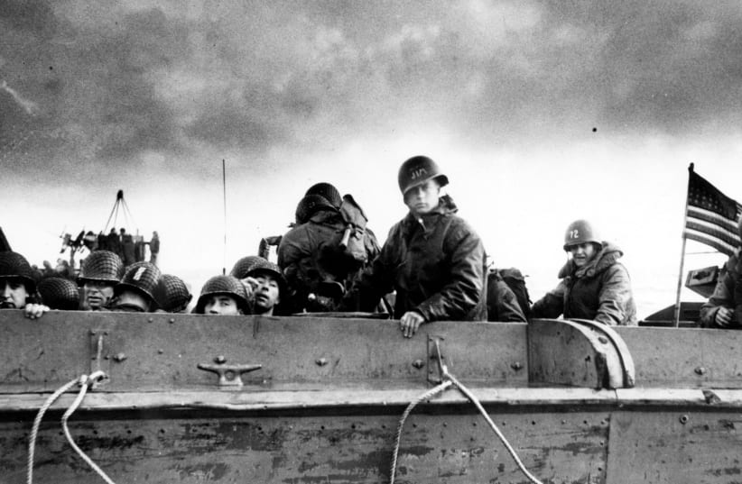U.S. Army troops and crewmen aboard a Coast Guard manned LCVP approach a beach on D-Day in Normandy in 1944 (photo credit: REUTERS)