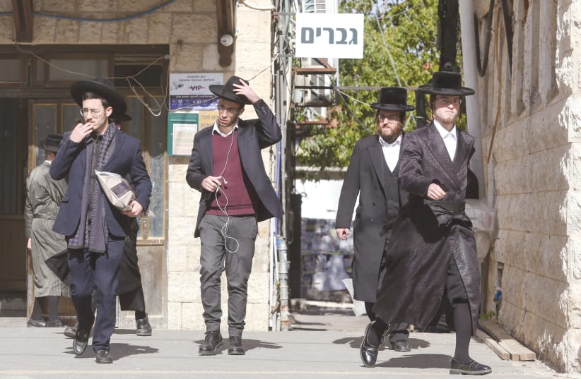 HAREDIM WALK in Jerusalem in front of a ‘Men Only’ sign – the role of religion in public life will likely increase due to demographic trends and the high birth rate in the haredi and national-religious sectors. (photo credit: MARC ISRAEL SELLEM/THE JERUSALEM POST)