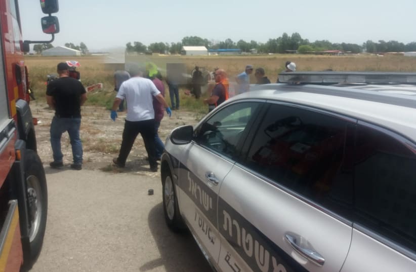 Medics and police crowd around the site of a glider crash near Megido Airport in Emek Izrael. (photo credit: POLICE SPOKESPERSON'S UNIT)