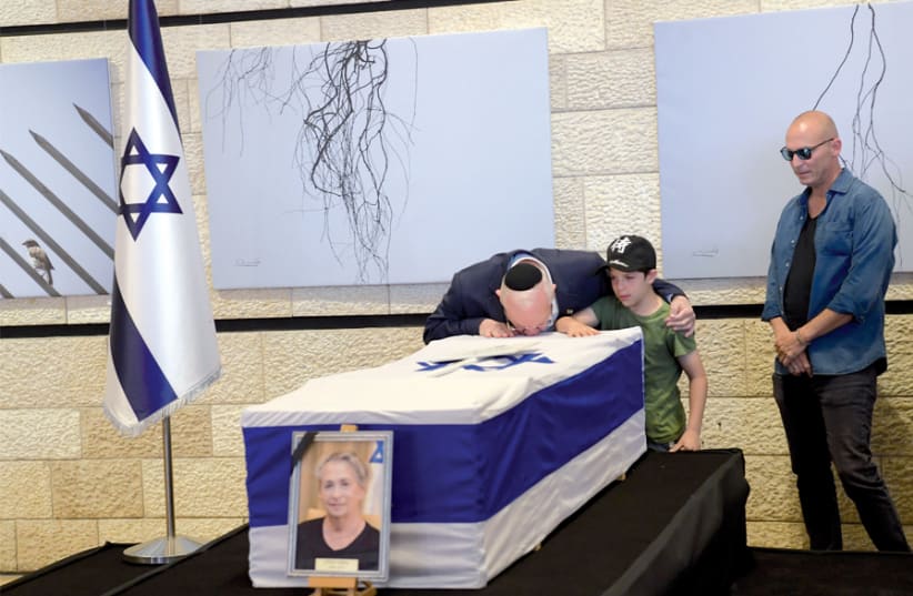 resident Reuven Rivlin kisses the coffin of his wife, Nechama, at the Jerusalem Theater on June 5, before her funeral on Mount Herzl. (photo credit: GPO/AMOS BEN GERSHOM)