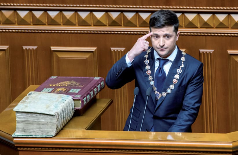 Ukraine President Volodymyr Zelensky takes the oath during his inauguration ceremony in parliament hall in Kiev on May 20 (photo credit: VLADYSLAV MUSIIENKO / UKRAINIAN GOVERNMENTAL PRESS SERVICE / REUTERS)