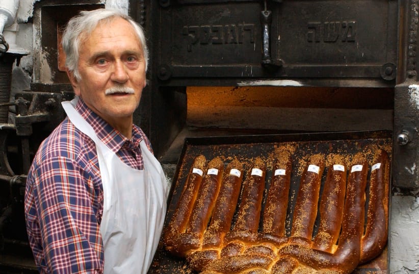 Matti Lendner bakes challah for Hanukkah inside his bakery in 2005.  (photo credit: Mark Neiman/GPO)