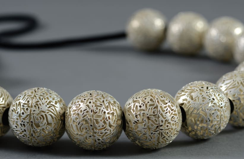 BEAD LANGUAGE by Amit Shur feeds off old and new, comprising silver beads with delicate Muslim calligraphy and 3D printing. (photo credit: SHAI BEN EFRAIM)