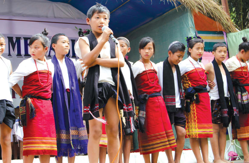 BNEI MENASHE youth in Manipur, India, wearing traditional cultural garments. Notice their traditional fringes mixed with the modern fringes of their tzitzit. (photo credit: LAURA BEN-DAVID)
