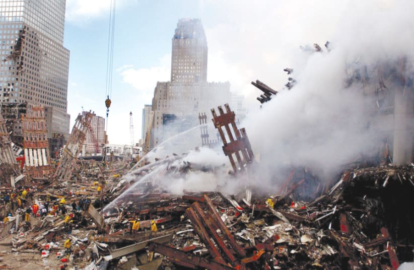 FIRES STILL burn amid the rubble and debris of New York City’s World Trade Center on September 13, 2001, two days after the 9/11 terrorist attacks. (photo credit: Wikimedia Commons)