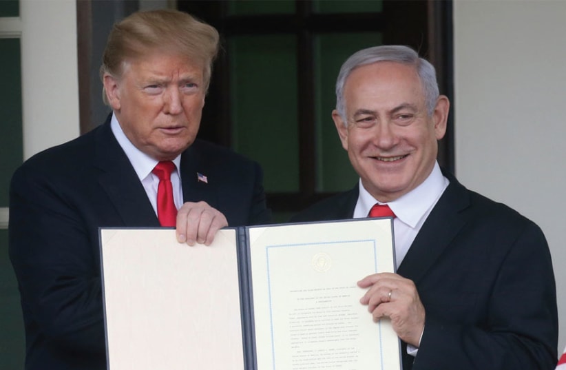 US PRESIDENT Donald Trump and Prime Minister Benjamin Netanyahu hold up a proclamation recognizing Israel’s sovereignty over the Golan Heights at the White House in March. (photo credit: LEAH MILLIS/REUTERS)