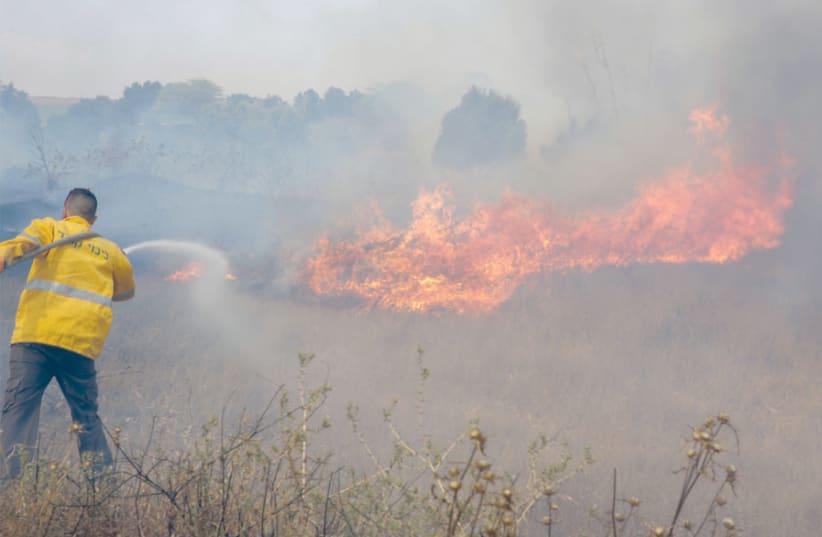 FIGHTING A fire in a blazing field. (photo credit: YEHUDA PERETZ/KKL-JNF PHOTO ARCHIVE)