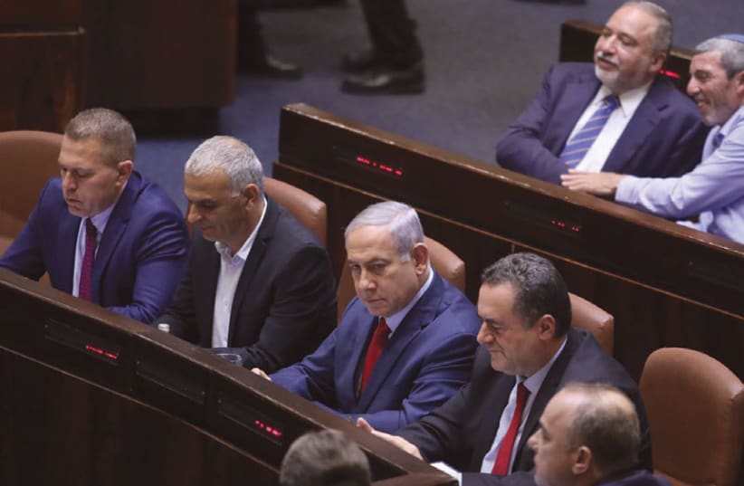 PRIME MINISTER Benjamin Netanyahu, with Avigdor Liberman in the row behind him, sits in the Knesset on May 29, the night MKs voted to go to new elections. (photo credit: MARC ISRAEL SELLEM)