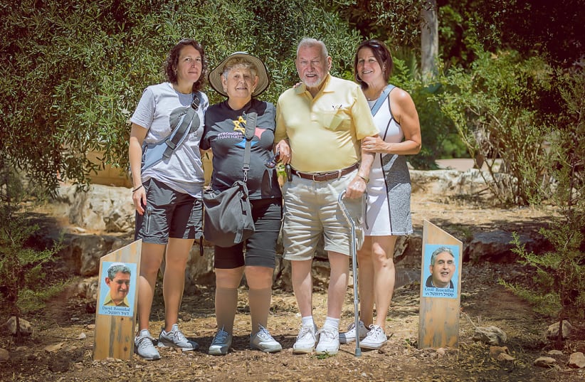 From left to right: Michele (sister), Joy (mother), Eli (father) and Diane (sister) Rosenthal, next to the trees planted in their brothers' memory (photo credit: NATASHA KUPERMAN)