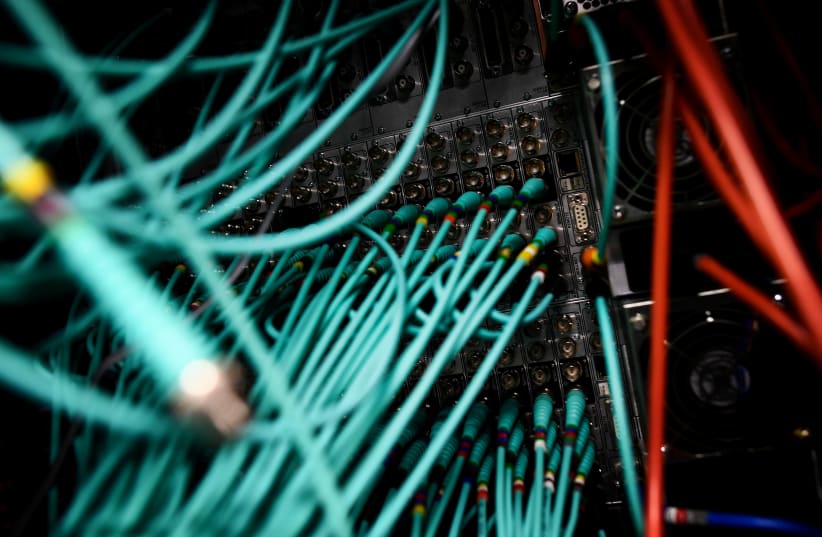 Cables and computers are seen inside a data centre at an office in the heart of the financial district in London, Britain May 15, 2017 (photo credit: REUTERS/DYLAN MARTINEZ)