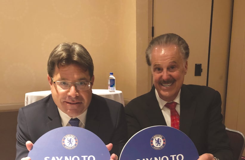 OFIR AKUNIS (L) and Dr. Mike Evans hold up ‘Say No to Antisemitism’ signs at the Jerusalem Post Conference in New York. (photo credit: Courtesy)
