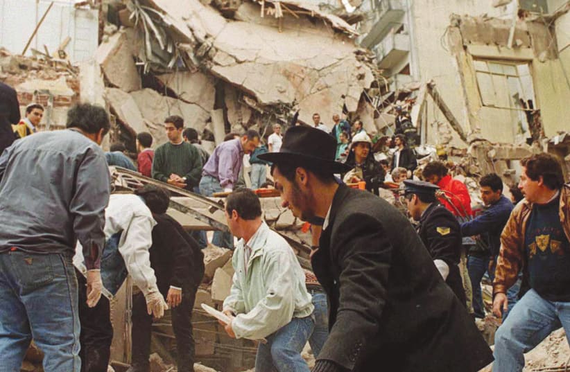 RESCUE WORKERS search for survivors and victims in the rubble left after a powerful car bomb destroyed the Buenos Aires headquarters of the Argentine Israeli Mutual Association (AMIA), in this July 18, 1994 photo (photo credit: REUTERS)